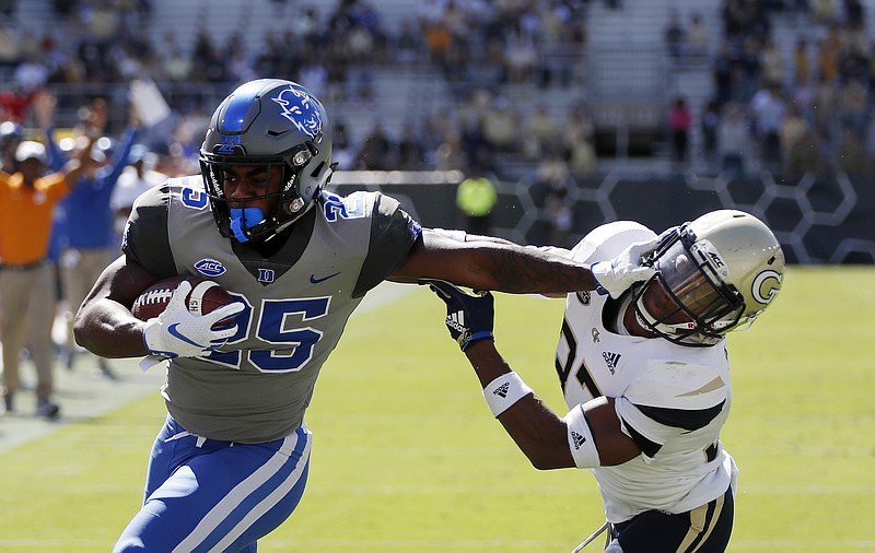 Duke running back Deon Jackson stiff-arms Georgia Tech defensive back Jaytlin Askew (33) on his way to the end zone during Saturday's ACC matchup in Atlanta.