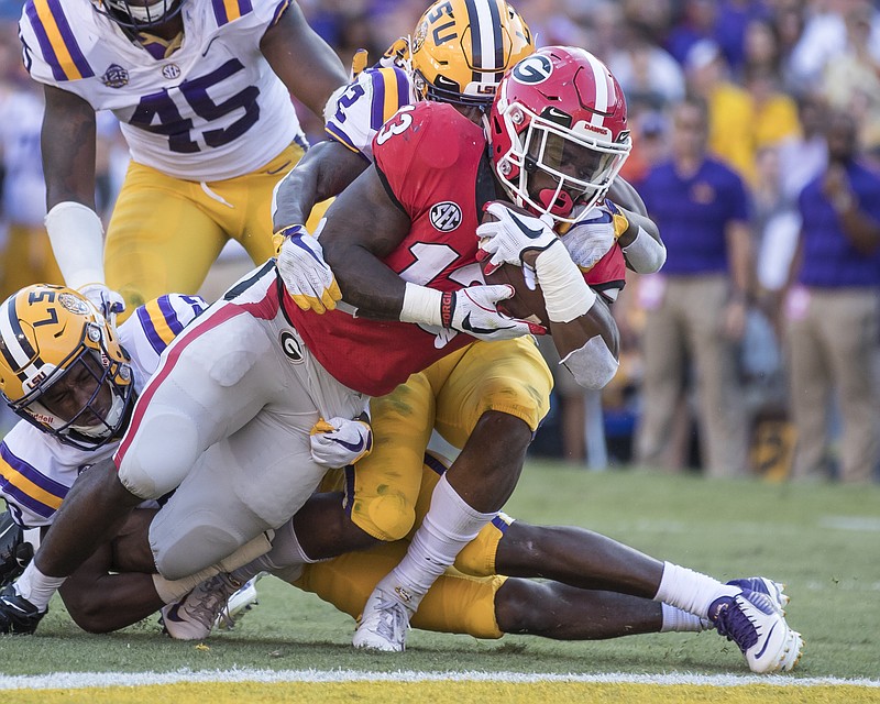 Georgia junior running back Elijah Holyfield scores on a 10-yard run late in the third quarter of Saturday's 36-16 loss to LSU. The Bulldogs are off next weekend before taking on Florida in Jacksonville on Oct. 27.