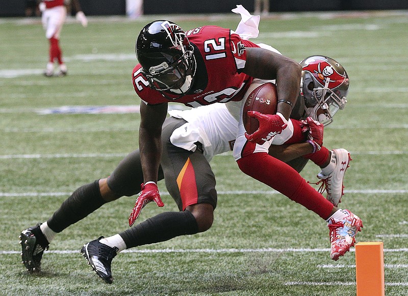 Atlanta Falcons wide receiver Mohamed Sanu dives into the end zone past Tampa Bay Buccaneers safety Justin Evans for a 35-yard touchdown catch during the first quarter of Sunday's NFC South game in Atlanta. Sanu finished with two catches for 46 yards, and the Falcons won 34-29 to end their losing streak at three games.