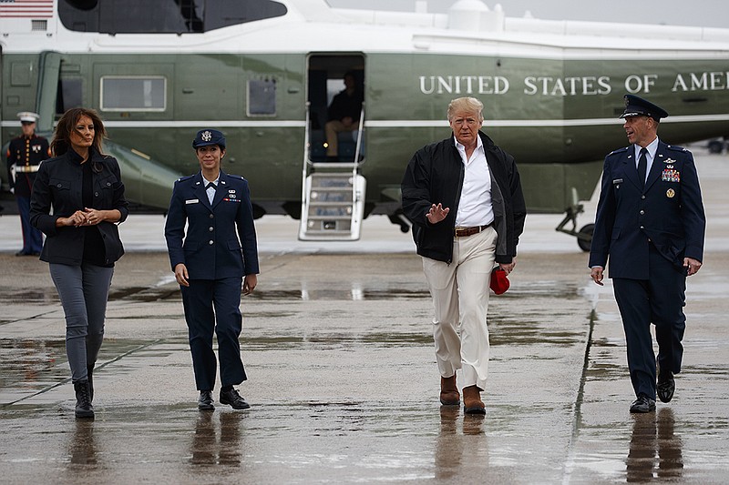 President Donald Trump and first lady Melania Trump board Air Force One for a trip to visit areas affected by Hurricane Michael, Monday, Oct. 15, 2018, in Andrews Air Force Base, Md. (AP Photo/Evan Vucci)

