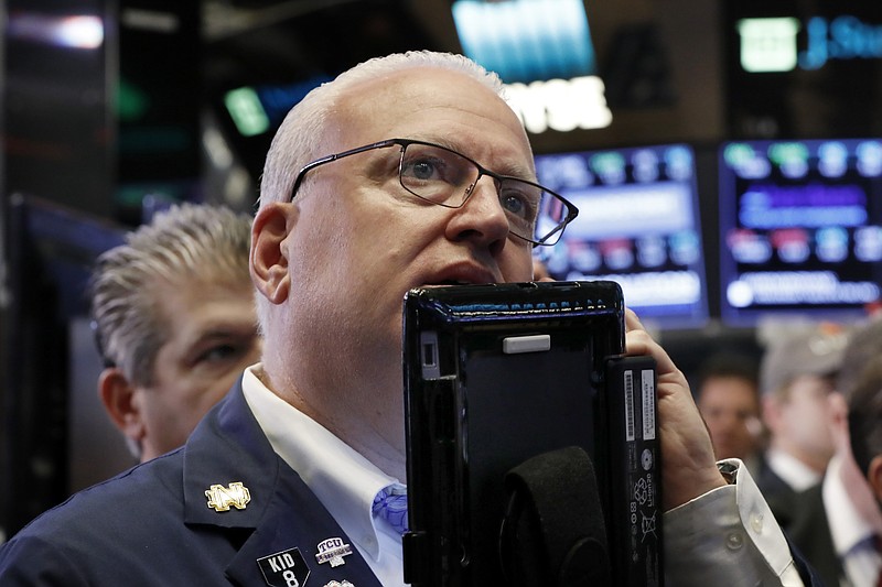 FILE- In this Oct. 11, 2018, file photo trader Thomas Ferrigno works on the floor of the New York Stock Exchange. The U.S. stock market opens at 9:30 a.m. EDT on Tuesday, Oct. 16. (AP Photo/Richard Drew, File)