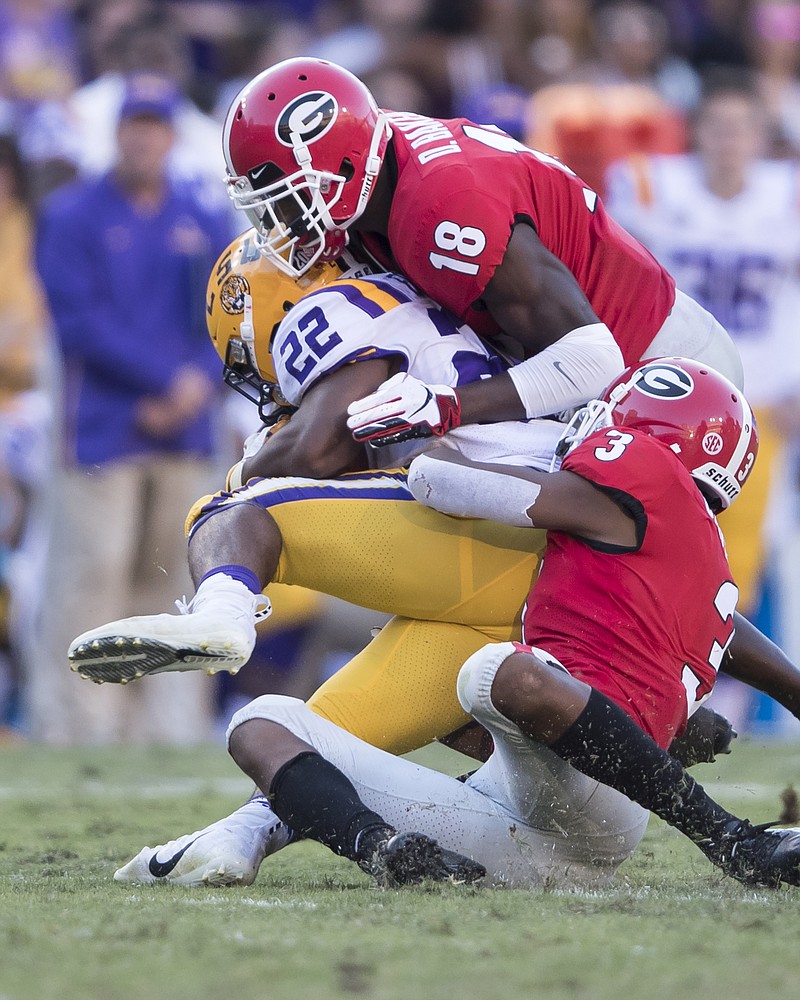 Georgia freshman cornerback Tyson Campbell (3) helps senior corner Deandre Baker (18) bring down LSU running back Clyde Edwards-Helaire during last Saturday's 36-16 loss to the Tigers.