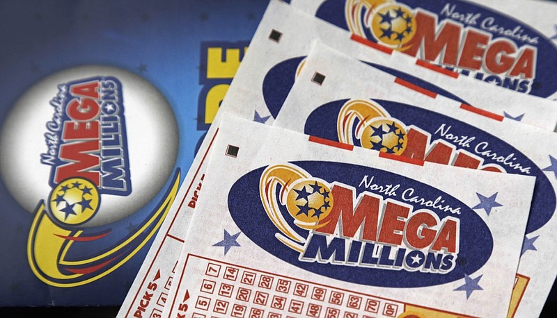 This July 1, 2016, file photo shows Mega Millions lottery tickets on a counter at a Pilot travel center near Burlington, N.C. After nearly three months without a winner, the Mega Millions lottery game has climbed to an estimated $654 million jackpot. Unfortunately, even as the big prize for its drawing Tuesday night, Oct. 16, 2018, increases to the fourth-largest in U.S. history , the odds of matching all six numbers and winning the game don't improve. They're stuck at a miserable one in 302.5 million. (AP Photo/Gerry Broome, File)