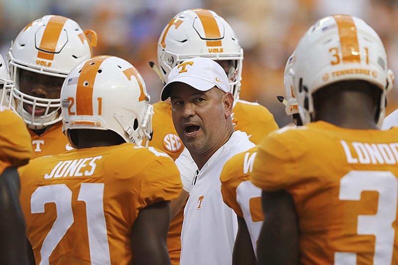 Tennessee football coach Jeremy Pruitt talks to his players during warmups before their home game against Florida on Sept. 22. Pruitt didn't want to be specific about the injury status of certain players Wednesday with a visit from top-ranked Alabama just three days away.