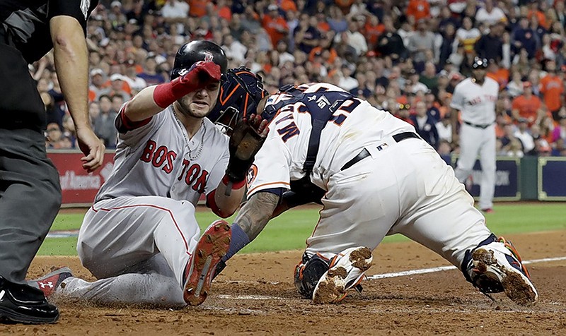 Boston's Andrew Benintendi, left, scores past Houston catcher Martin Maldonado on a single by Xander Bogaerts during the fifth inning of Game 4 of the ALCS on Wednesday night in Houston. The Red Sox won 8-6 to take a 3-1 lead over the Astros in the best-of-seven series.