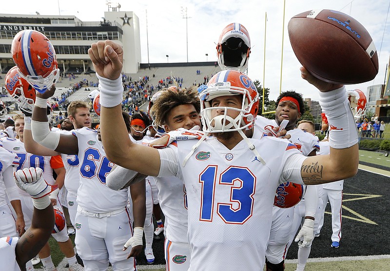Florida quarterback Feleipe Franks (13) celebrates with teammates after last Saturday's 37-27 win at Vanderbilt, which gave the Gators a 6-1 record enting next week's rivalry game against Georgia.