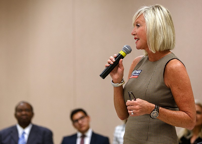 District 30 Republican candidate Esther Helton speaks during a meet-and-greet last month hosted by the League of Women Voters, while her opponent, Democrat Joda Thongnopnua, second from left, waits to speak.