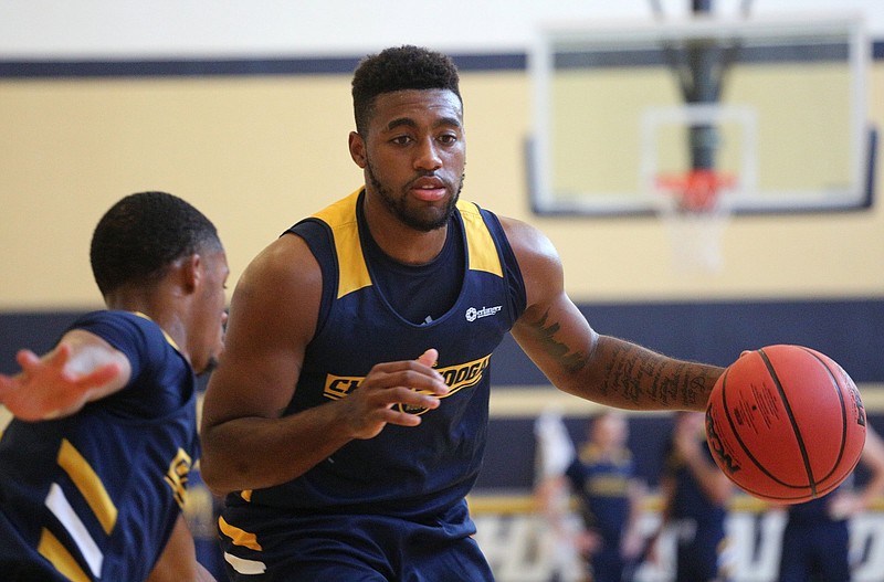 UTC's Jerry Johnson, shown dribbling during the first day of basketball practice last month, has been impressed with the attitude of his freshman teammates.