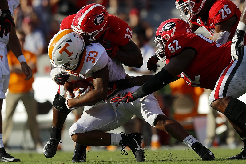 Tennessee running back Jeremy Banks is hit by Georgia linebacker Monty Rice (32) as defensive lineman Tyler Clark (52) closes in during their SEC East matchup on Sept. 29 in Athens. The Vols averaged 2.6 rushing yards per carry that day and lost the game 38-12.