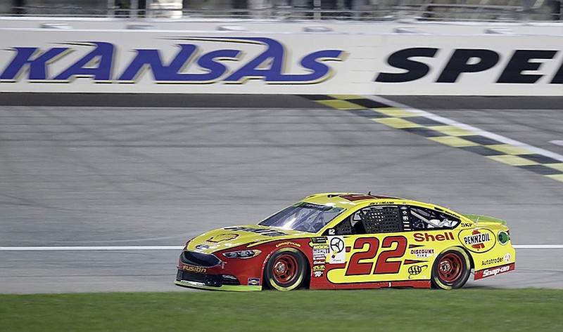 NASCAR Cup Series driver Joey Logano crosses the start/finish line at Kansas Speedway on Friday to earn the pole position for Sunday's playoff race.