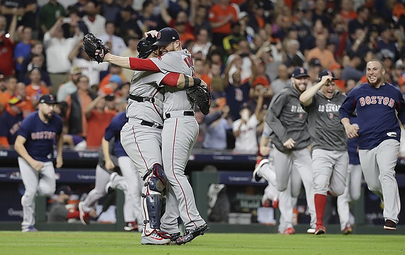 Boston closer Craig Kimbrel, right, celebrates with catcher Christian Vazquez after the Red Sox beat the Houston Astros on Thursday night to win the American League Championship Series in Houston. Boston won 4-1 to take the best-of-seven series in five games.