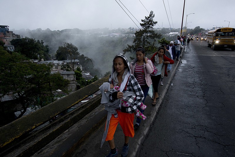Honduran migrants leave Guatemala City at sunrise Thursday as they make their way north toward the U.S.