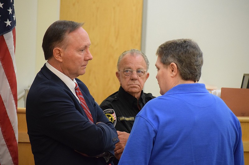 During a break in the August 2018 murder trial of Angela Kilgore in Marion County, 12th Judicial District Public Defender Jeff Harmon, left, talks with Kilgore, right, as Marion County Court Officer Kenny Barnett stands nearby.