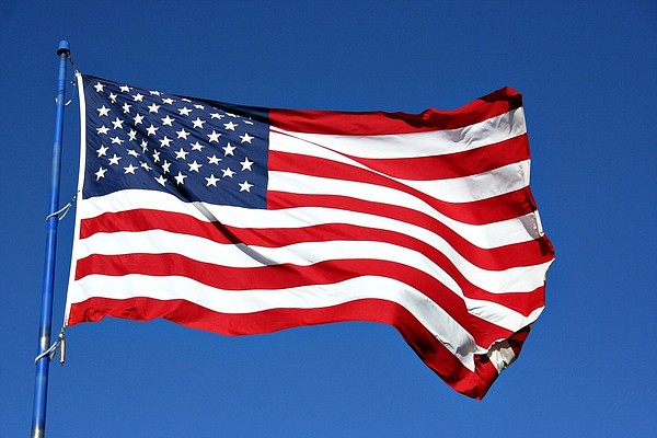 An American flag flutters in the breeze in this file photo. (c) BrandonSeidel | Dreamstime.com