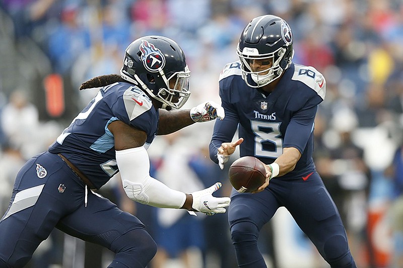 Tennessee Titans quarterback Marcus Mariota hands off to running back Derrick Henry during a 21-0 loss to the Baltimore Ravens on Oct. 14 in Nashville.