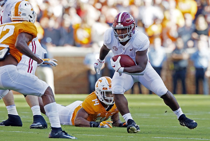 Alabama running back Josh Jacobs picks up yards after Tennessee linebacker Quart'e Sapp, on ground, missed a tackle during the first half of Saturday's SEC matchup in Knoxville.