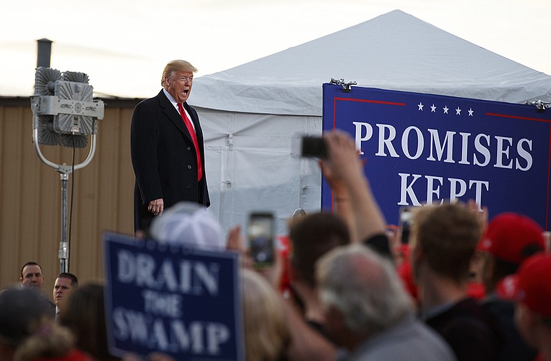 President Donald Trump calls out as he arrives at a campaign rally at Minuteman Aviation Hangar, Thursday, Oct. 18, 2018, in Missoula, Mont. (AP Photo/Carolyn Kaster)