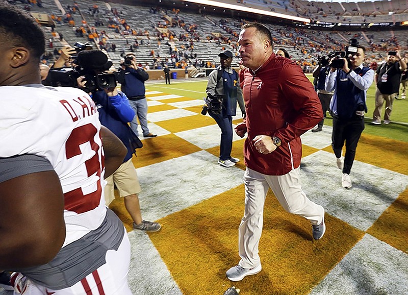 Former Tennessee football head coach Butch Jones, now an offensive analyst at Alabama, runs off the field after the top-ranked Crimson Tide routed the host Volunteers on Saturday afternoon in Knoxville.