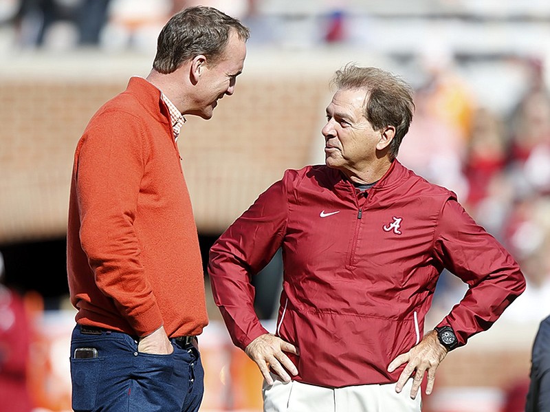 Alabama football coach Nick Saban talks with former Tennessee quarterback Peyton Manning on Saturday at Neyland Stadium in Knoxville.