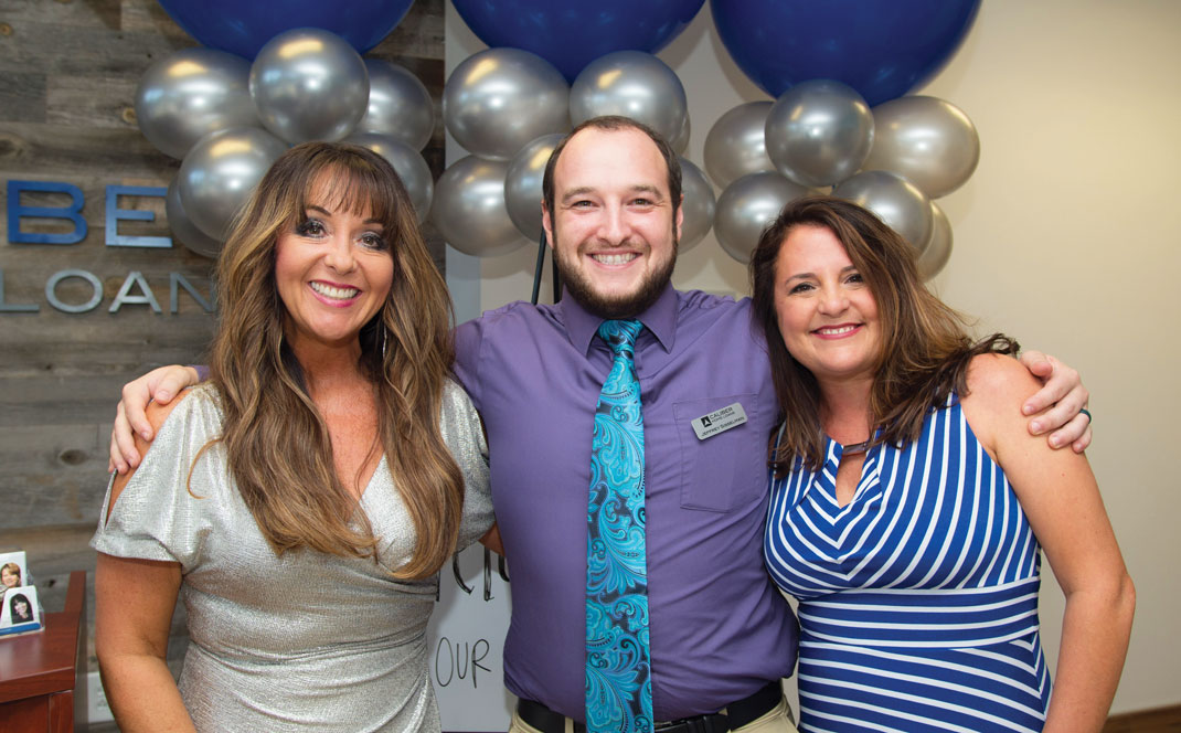 Vickie Phillips, Jeffrey Sisselman and Denise Monroe celebrate the opening of Caliber Home Loans' new office.