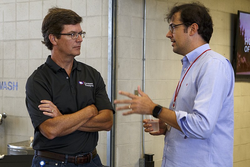 Covenant Transport President Joey Hogan, left, speaks with Logistics Exchange's Chief Technology Officer Stefan Friederichs during a Dynamo Venture meeting at Covenant Transport in October.