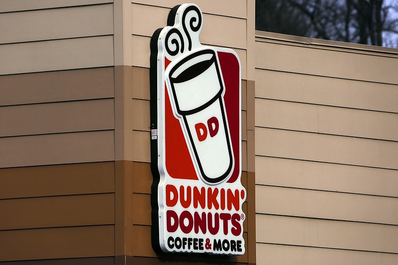 FILE- This Jan. 22, 2018, file photo shows the Dunkin' Donuts logo on a shop in Mount Lebanon, Pa. First, Dunkin' dropped the "Donuts" from its name. Now, it's adding espresso drinks to its menu. Dunkin' says most of its 9,200 U.S. stores will offer lattes, cappuccinos and other espresso-based hot and cold drinks by the holiday season. (AP Photo/Gene J. Puskar, File)