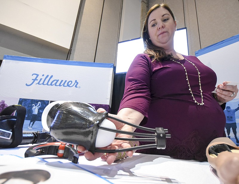 Fillauer marketing manager Amy Duck holds the prosthetic device, Nexo, that netted the 2018 Spirit of Innovation Award Wednesday for the Fillauer company at the Chattanooga Area Chamber's Spirit of Innovation awards luncheon at the Chattanooga Convention Center.