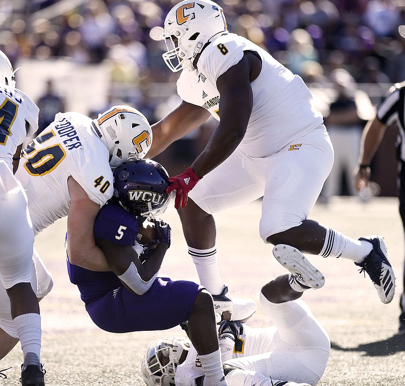 UTC's Marshall Copper (40), Rashun Freeman, on ground, and Isaiah Mack tackle Western Carolina's Connell Young during their SoCon matchup Oct. 13 in Cullowhee, N.C. Mack and fellow defensive linemen Khayyan Edwards and Derek Mahaffey have a weekly competition to see who can get the most sacks in a game.