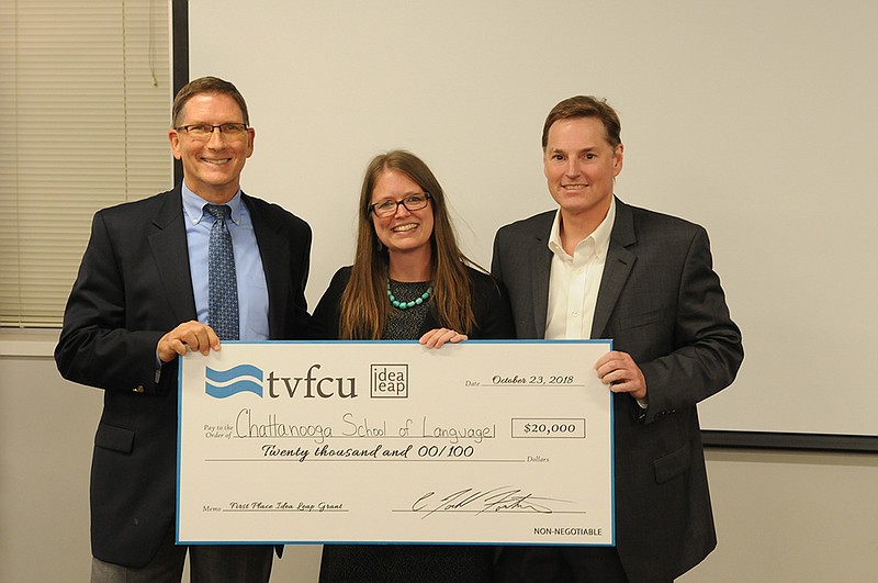 Chattanooga School of Language Founder Laurie Stevens, center, receives $20,000 grant from Tennessee Valley Federal Credit Union President Todd Fortner, right, and vice president Tommy Nix, left, after she was picked at the top winner in the Idea Leap contest for small businesses.
