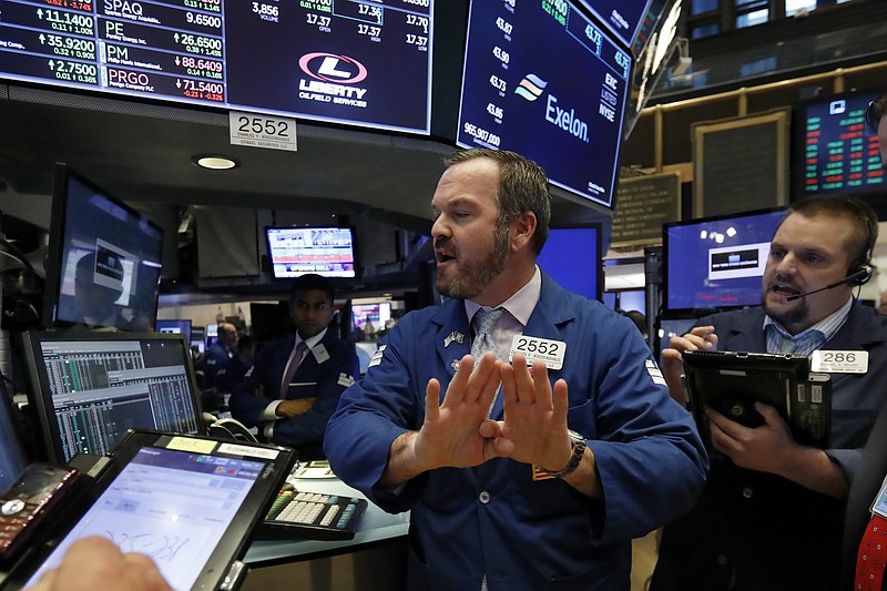 Specialist Charles Boeddinghaus, center, and trader Michael Milano work on the floor of the New York Stock Exchange, Wednesday, Oct. 24, 2018. Stocks are off to a mixed start on Wall Street as gains for Boeing and other industrial companies are offset by losses elsewhere in the market. (AP Photo/Richard Drew)
