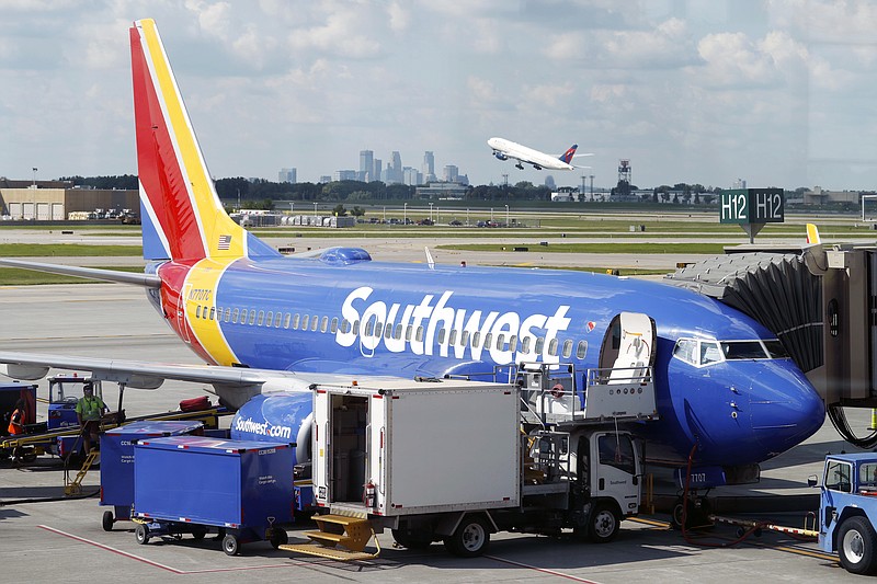 FILE- In this July 17, 2018, file photo ramp workers prepare a Southwest Airlines Boeing 737 for departure to Denver from Minneapolis International Airport in Minneapolis. Southwest Airlines Co. reports earnings Thursday, Oct. 25. (AP Photo/David Zalubowski, File)