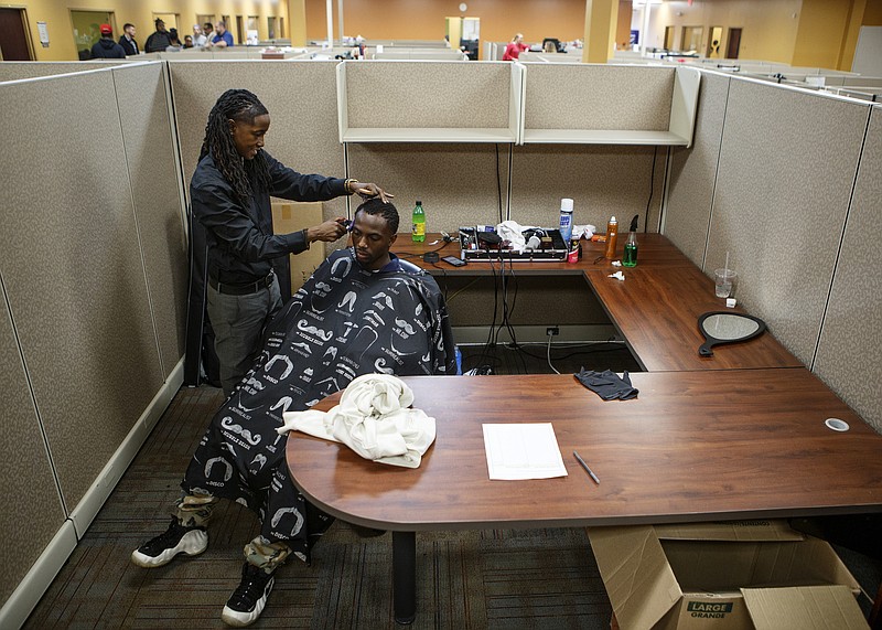 J-CuttinUp, left, gives a haircut to Kevon Johnson during the Career Preparation Day for A New Life Job Fair at the American Job Center in the Eastgate Towne Center on Thursday, Oct. 25, 2018 in Chattanooga, Tenn. The preparation day offered haircuts, business attire, resume and interview classes and other resources.