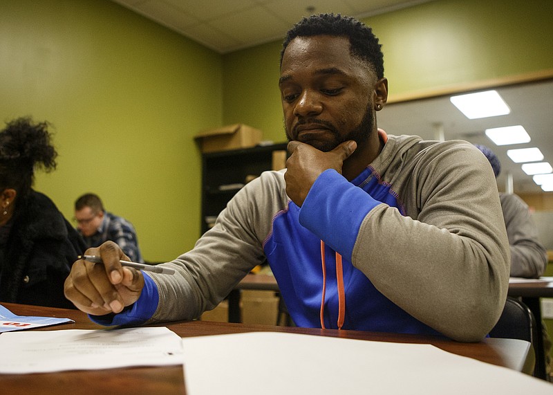 Tony Taylor works on writing down two positive traits for introducing himself during job interviews in the job preparation class during the Career Preparation Day for A New Life Job Fair at the American Job Center in the Eastgate Towne Center on Thursday, Oct. 25, 2018 in Chattanooga, Tenn. The preparation day offered haircuts, business attire, resume and interview classes and other resources.