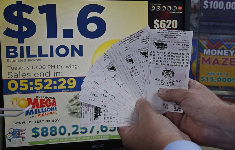 A customer, who did not want to be identified, displays the $200.00 worth of Mega Millions tickets he bought at Downtown Plaza convenience store in Oklahoma City, Tuesday, Oct. 23, 2018. (AP Photo/Sue Ogrocki)

