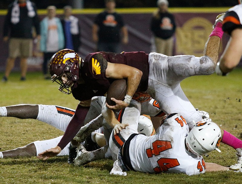 Grace Baptist Academy player Cade Tinsley (9) tumbles over Middle Tennessee Christian School player Trey Harris (44) during Grace's football game against MTCS at Grace Baptist Academy on Friday, Oct. 26, 2018, in Chattanooga, Tenn. 