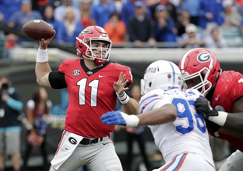 Georgia quarterback Jake Fromm (11) prepares to pass as Florida defensive lineman Cece Jefferson tries to create pressure during Saturday's game in Jacksonville, Fla.