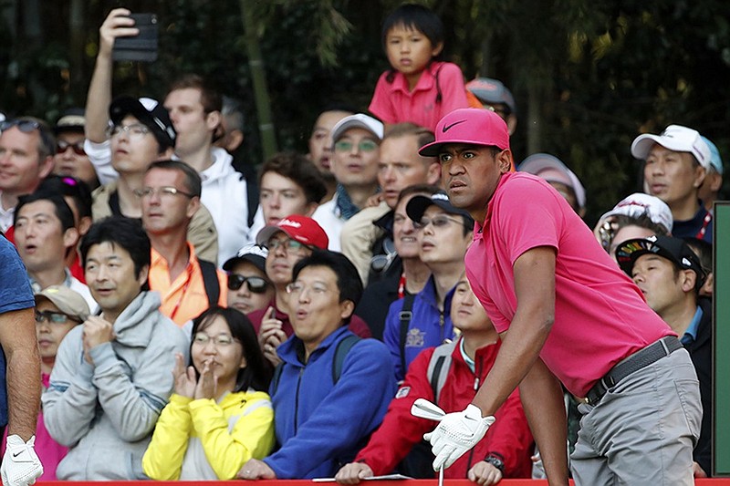 PGA Tour golfer Tony Finau and spectators in the gallery track one of his shots Saturday during the third round of the HSBC Champions in Shanghai.