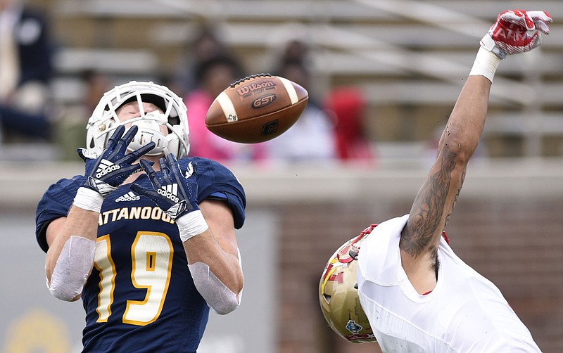 UTC receiver Bryce Nunnelly (19) goes up for a pass over VMI's Kaleb Thornton on Oct. 27 at Finley Stadium.