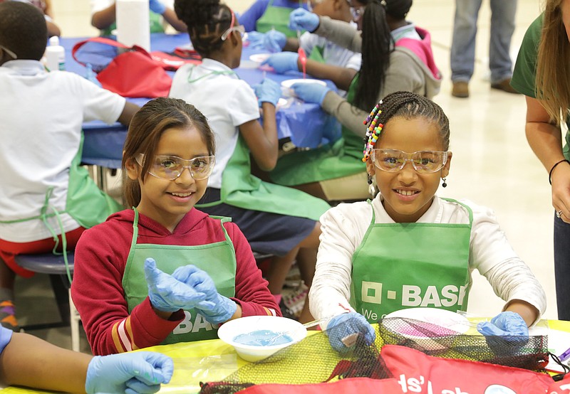 Orchard Knob Elementary fifth graders Sharmain Horton, left, and Emily Rivera participate in Chemistry Day on Oct. 4 at the school. In celebration of the day, BASF employees provided interactive demonstrations and hands-on experiences for students and their teachers through the BASF Kids' Lab program. Here the students are creating slime. Contributed photo/Times Free Press