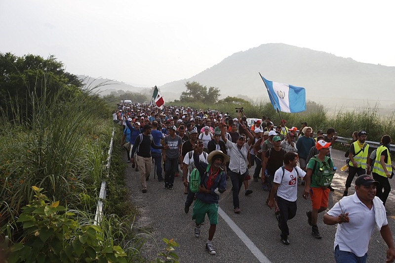 Migrants walk along the road after Mexico's federal police briefly blocked the highway in an attempt to stop a thousands-strong caravan of Central American migrants from advancing, outside the town of Arriaga, Chiapas State, Mexico, Saturday, Oct. 27, 2018. Hundreds of Mexican federal officers carrying plastic shields had blocked the caravan from advancing toward the United States, after several thousand of the migrants turned down the chance to apply for refugee status and obtain a Mexican offer of benefits. (AP Photo/Rebecca Blackwell)

