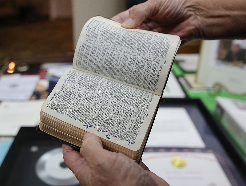 Philip George Garver shows off the Bible he carried while in the Vietnam War during an interview Wednesday, October 17, 2018 in Collegedale, Tennessee. Garver wrote numbers by verses to represent the day he was in Vietnam. 