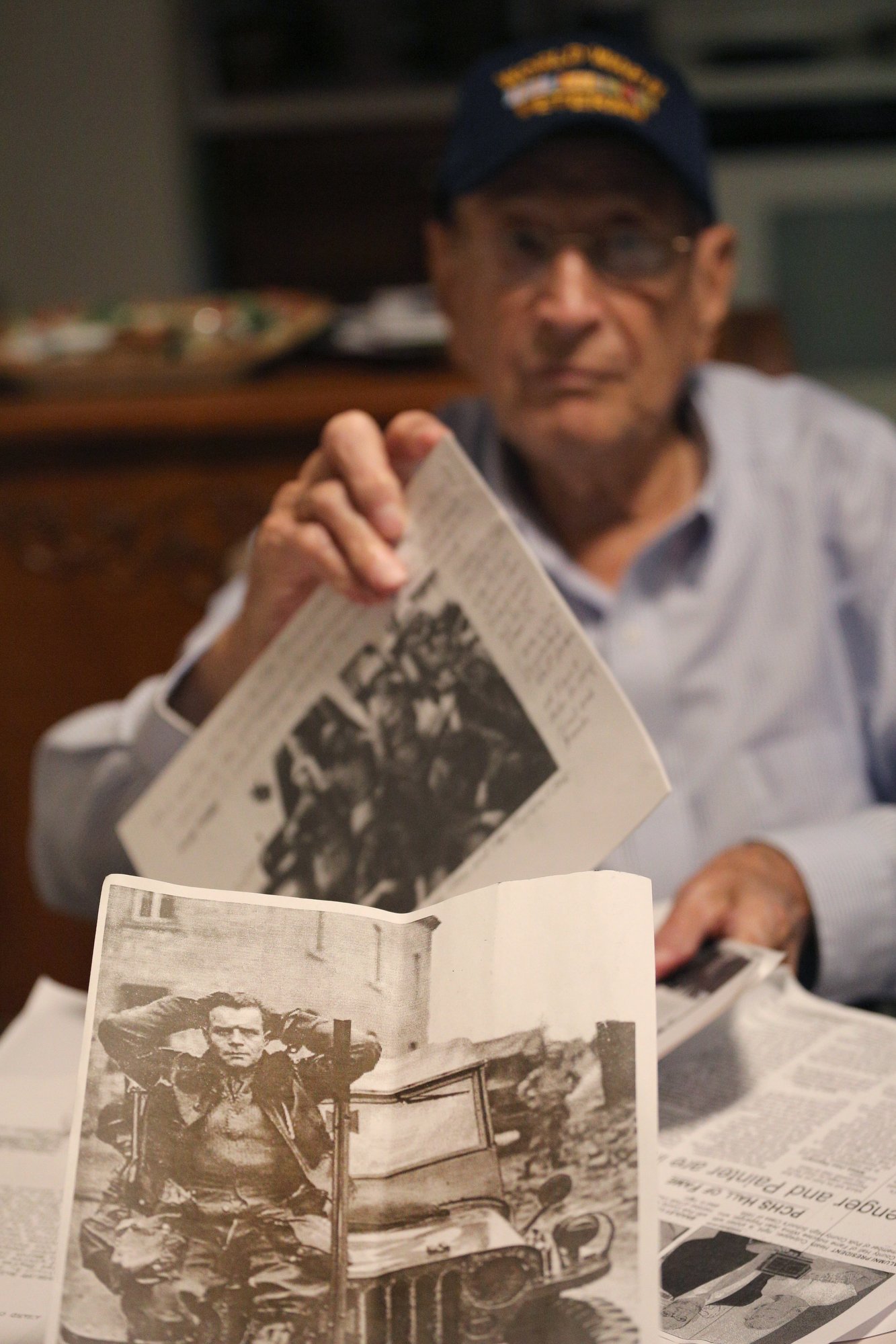 A photo of a prisoner Ralph Painter said he shot down in World War II is among the photos and paperwork he pulls out during an interview Monday, October 15, 2018 at his home in East Brainerd, Tennessee. Painter was a staff sergeant in the Battery B in the 87th Armored Field Artillery Battalion.