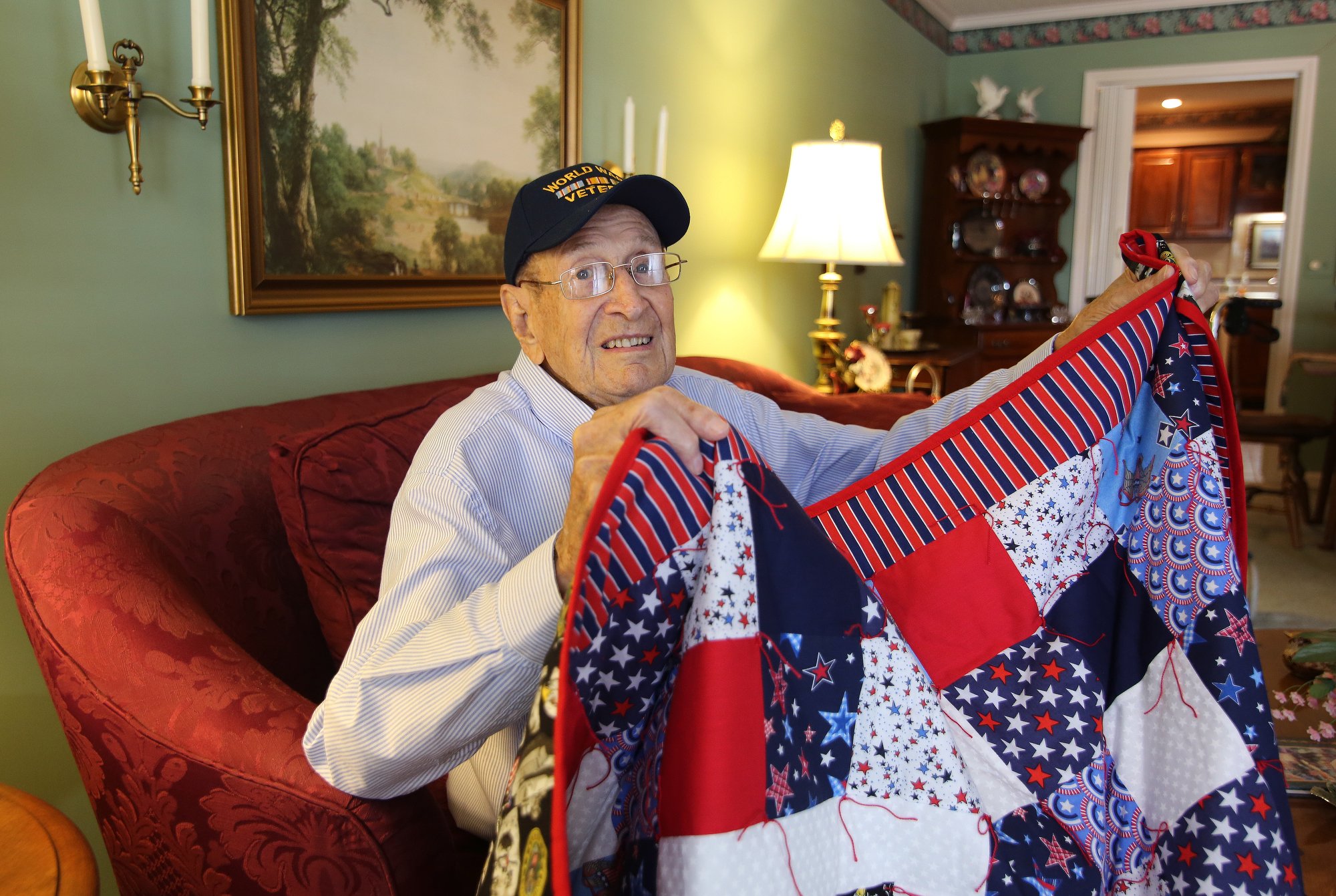 Ralph Painter shows off a blanket he was gifted for his service in World War II at his home in East Brainerd, Tennessee, Monday, October 15, 2018. Painter was a staff sergeant in the Battery B in the 87th Armored Field Artillery Battalion.