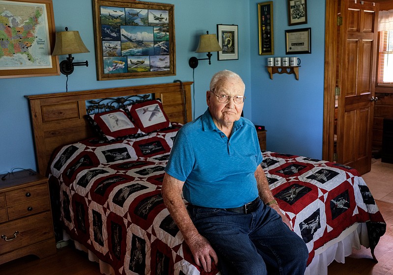 World War II veteran Horace Feezell poses for a portrait on a bed with an aircraft-themed quilt in his home on Thursday, Oct. 11, 2018, in Athens, Tenn. Feezell served in the U.S. Army Air Forces and was a prisoner of war in Europe after his aircraft was shot down.