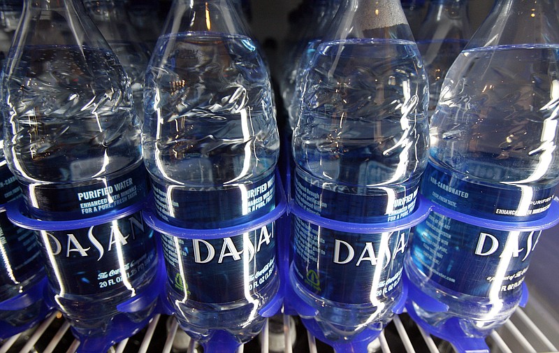 FILE - In this Dec. 9, 2009, file photo, Dasani bottled water owned by Coca-Cola sits on the shelf in Montpelier, Vt. Strong sales of water and sugar-free drinks powered third-quarter earnings for Coca-Cola Co reported Tuesday, Oct. 30, 2018. AP Photo/Toby Talbot, File)