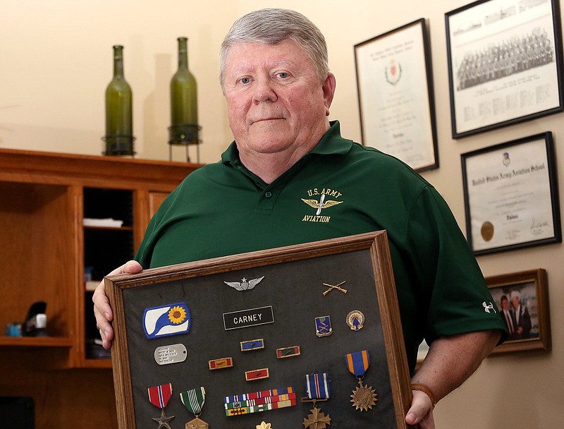 Jack Carney poses for a photo with medals and ribbons he earned while serving in the Army at his home Wednesday, October 10, 2018 in East Brainerd, Tennessee. 