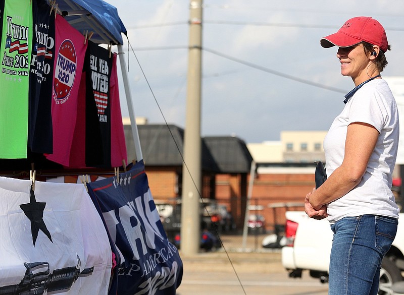 Stacy Kirby stops by a booth selling pro-President Donald Trump merchandise at the corner 20th Street and Broad Street Wednesday, October 31, 2018 in Chattanooga, Tennessee. Kirby said that she is planning on going the the rally Trump will be attending Sunday in Chattanooga. 