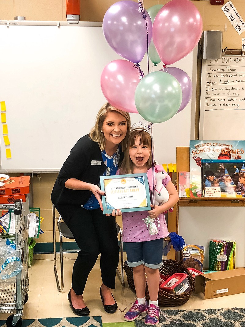 Stacey Beene, First Volunteer Market Leader, presents Jocelyn Pfeiffer, a Soddy Elementary first-grader, the Selfless Act Award.