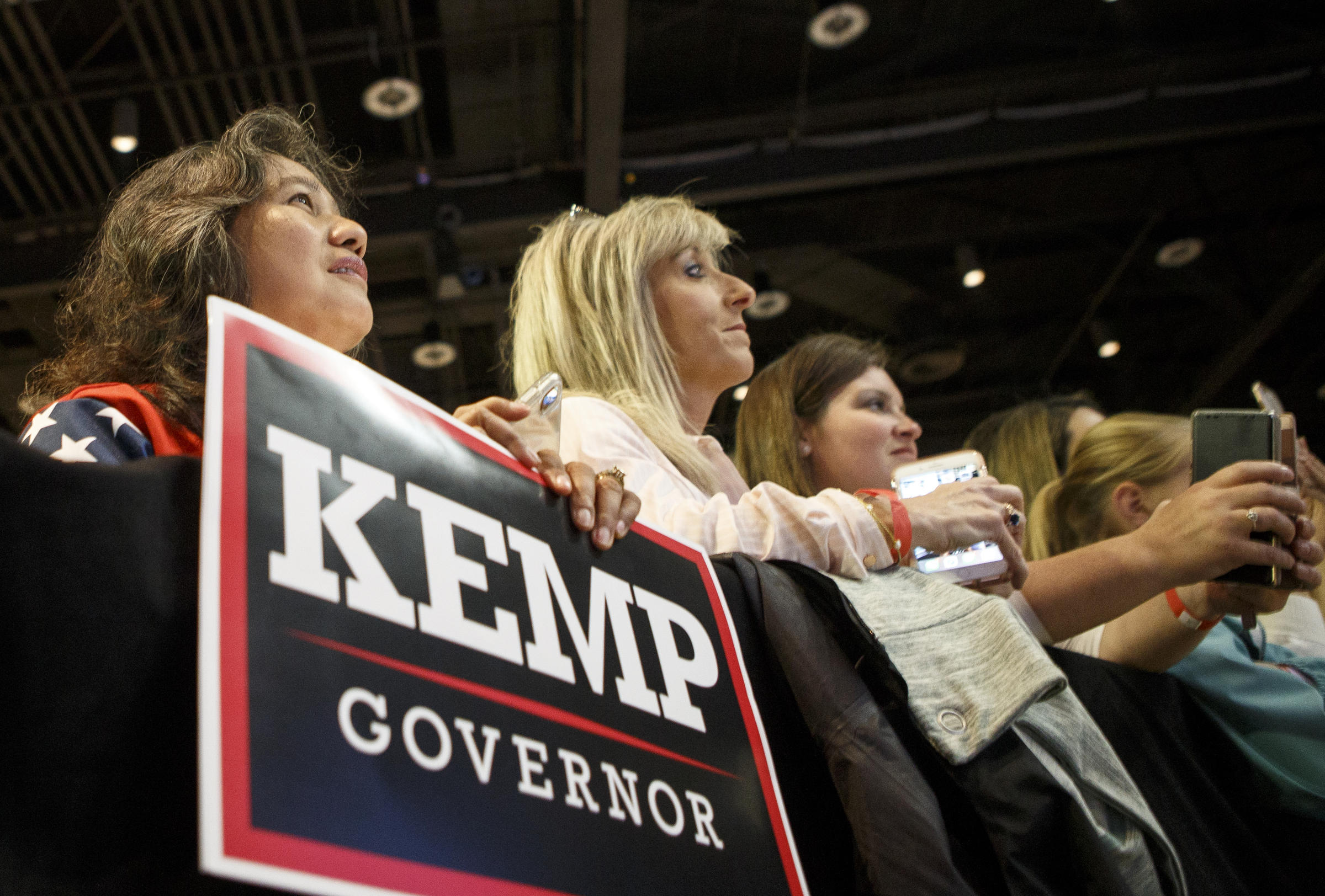 People listen as Vice President Mike Pence speaks during a "Get Out The Vote" rally while stumping for Republican gubernatorial candidate Brian Kemp at the Dalton Convention Center on Thursday, Nov. 1, 2018 in Dalton, Ga. Republican Brian Kemp is facing off against Democrat Stacey Abrams for governor in Georgia.