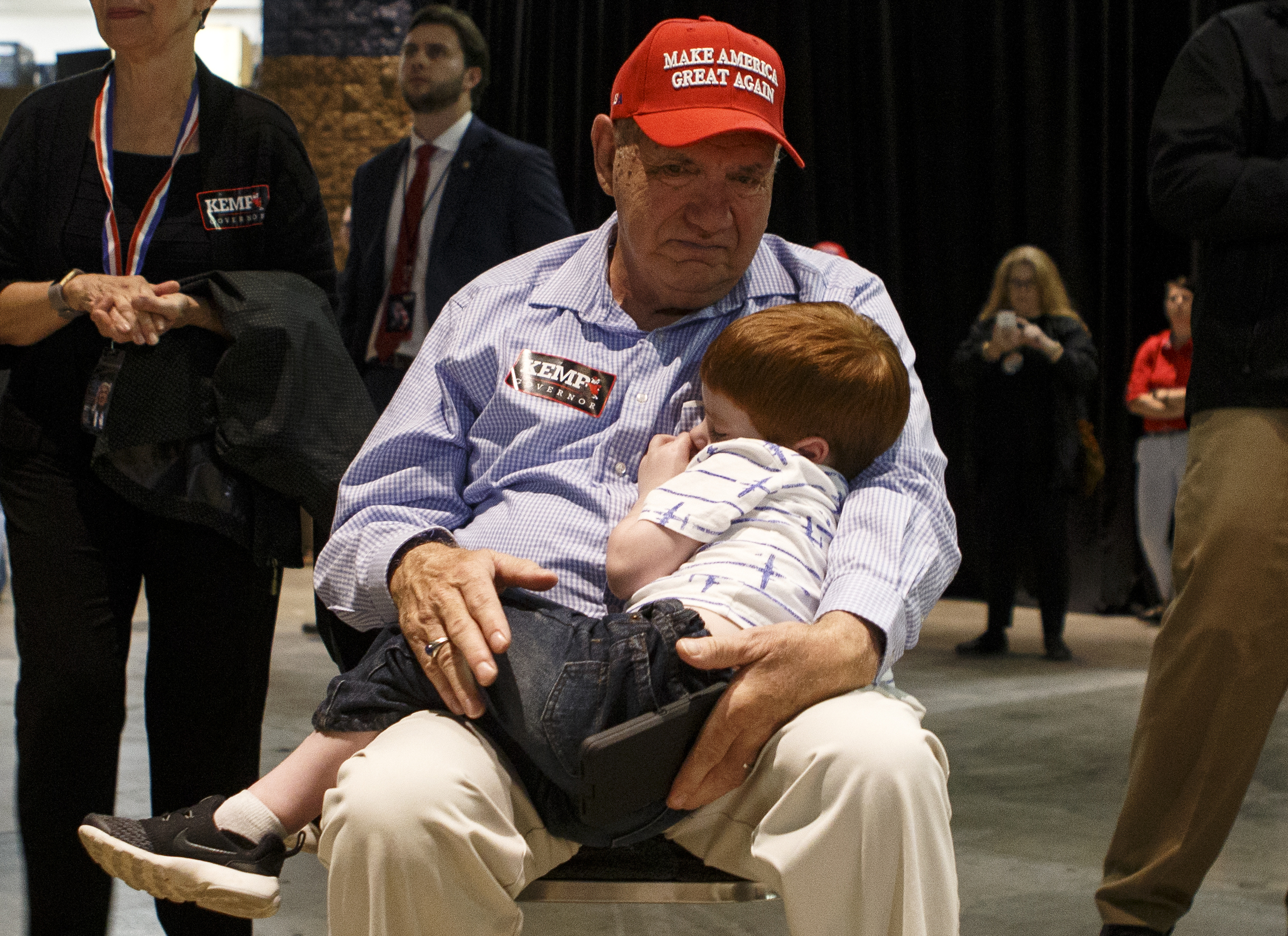 Tony Hohol, of Rocky Face, Ga., holds his sleeping 3-year-old grandson Henry Hudson during a "Get Out The Vote" rally featuring Vice President Mike Pence and Republican gubernatorial candidate Brian Kemp at the Dalton Convention Center on Thursday, Nov. 1, 2018 in Dalton, Ga. Republican Brian Kemp is facing off against Democrat Stacey Abrams for governor in Georgia.